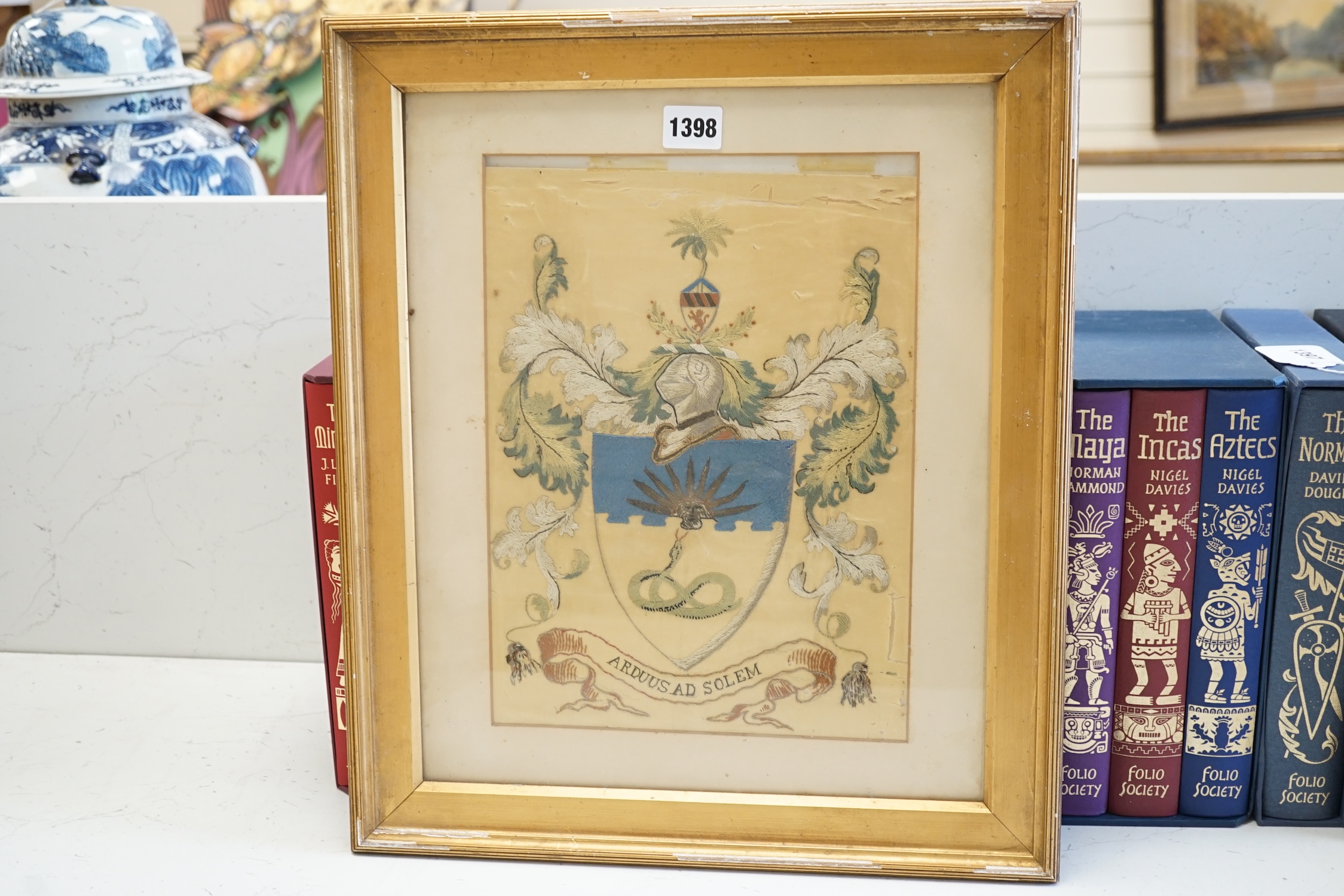 A 19th century silk embroidered coat of arms for Manchester University, 30.5cm high, 23cm wide. Condition - the main body of silk is damaged but embroidery colours good